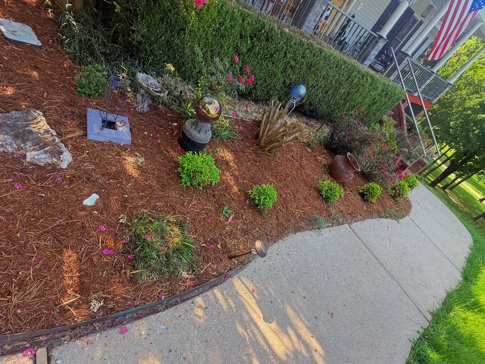 Finished foundation bed with fresh mulch, new shrubs and a clean sidewalk edge — recent Terrabyte project